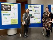 Marita Thomas and Jana Jerosch with CRC poster at the sponsors' exhibition.